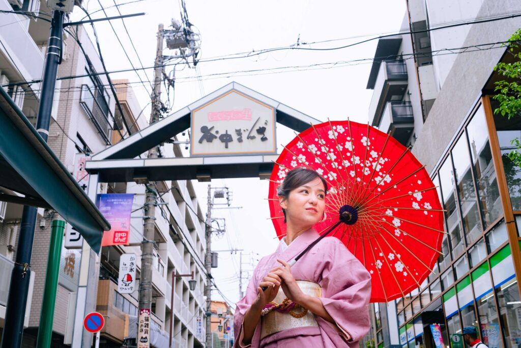 Woman wearing pink kimono at Yanaka Ginza shopping street in Tokyo