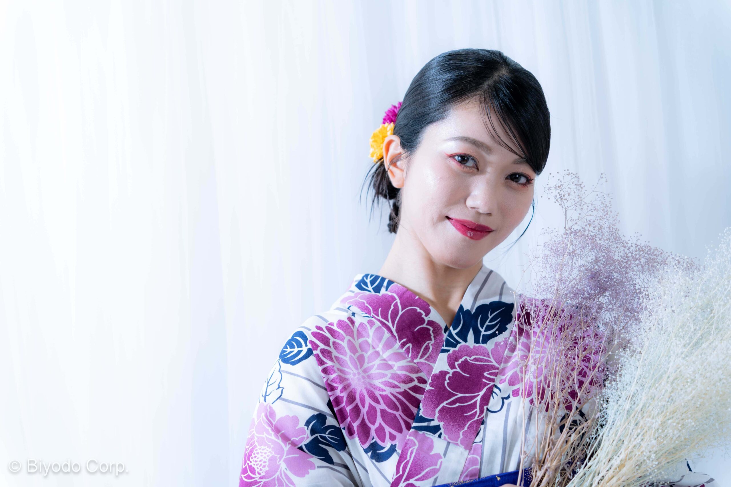 Woman wearing purple floral yukata with hair ornaments during studio photo session in Tokyo
