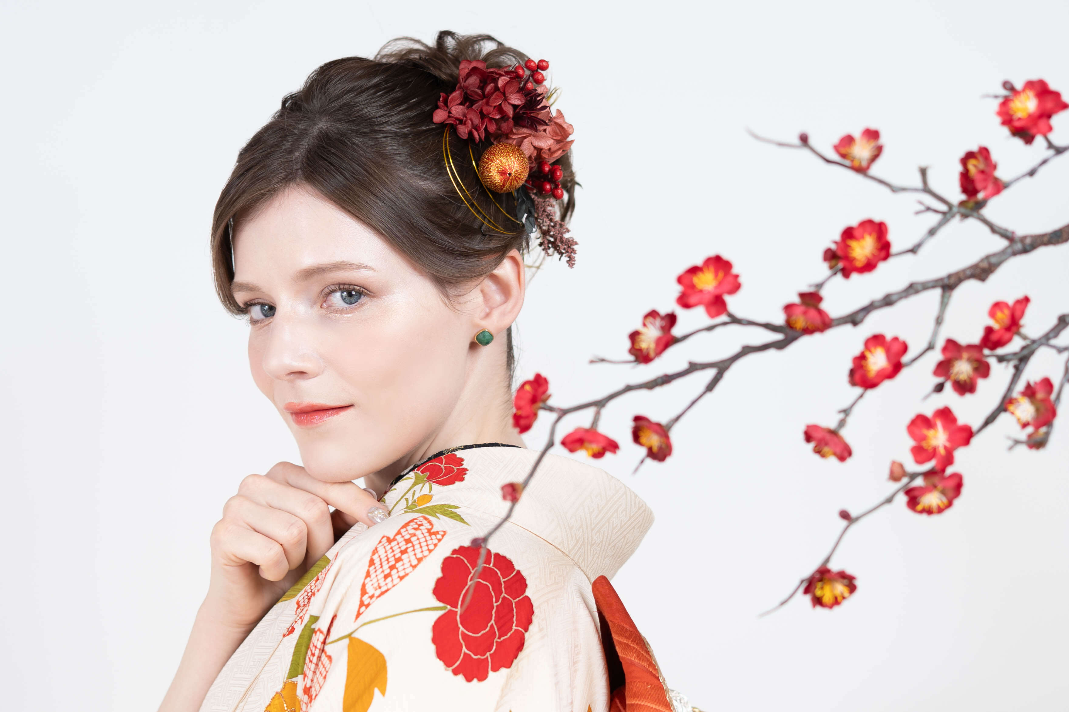 Woman in a Kimono Makeover Experience holding a plum blossom branch, Biyodo Tokyo